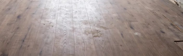 Abgenutzter alter Holzboden mit Flecken und Schäden